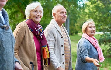 A Group of Elderly People Walking Outside