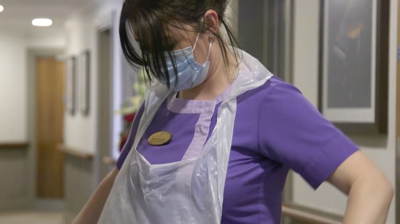 Nurse Putting Apron On