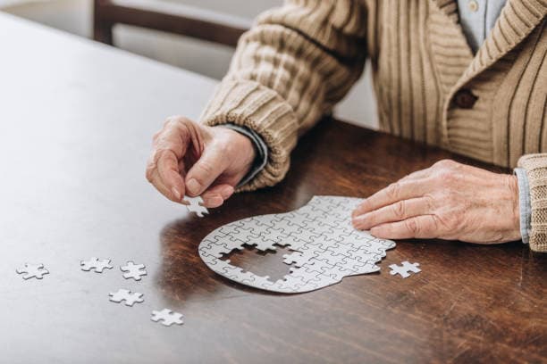 Older man doing a jigsaw