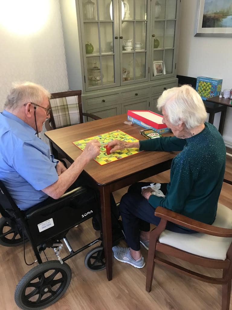 Residents Playing Snakes and Ladders