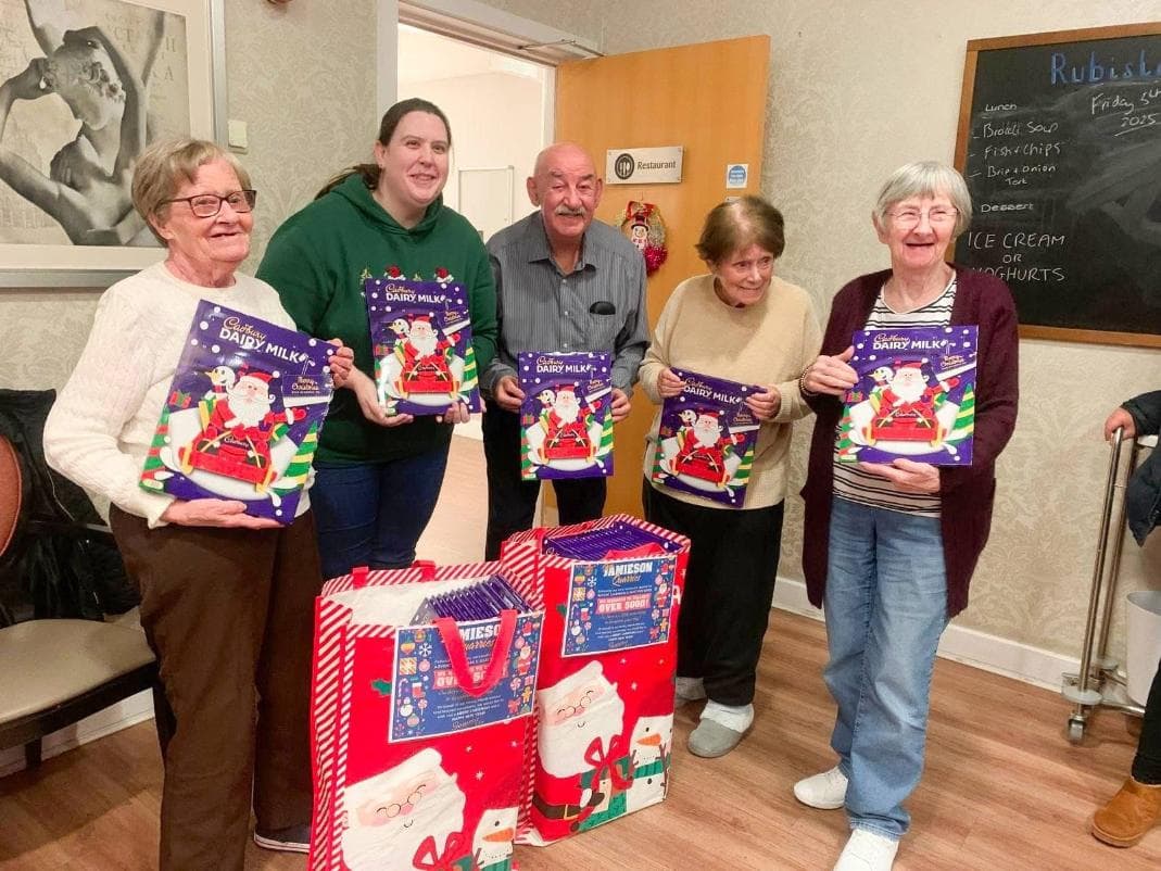 Care home residents holding their Christmas advent calendars