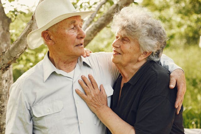 elderly couple talking in a park