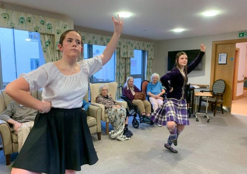 traditional Scottish dancers performing for care home residents