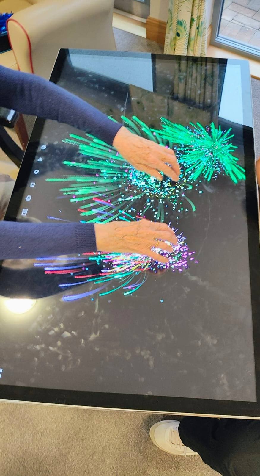 sensory tablet table and resident creating a drawing