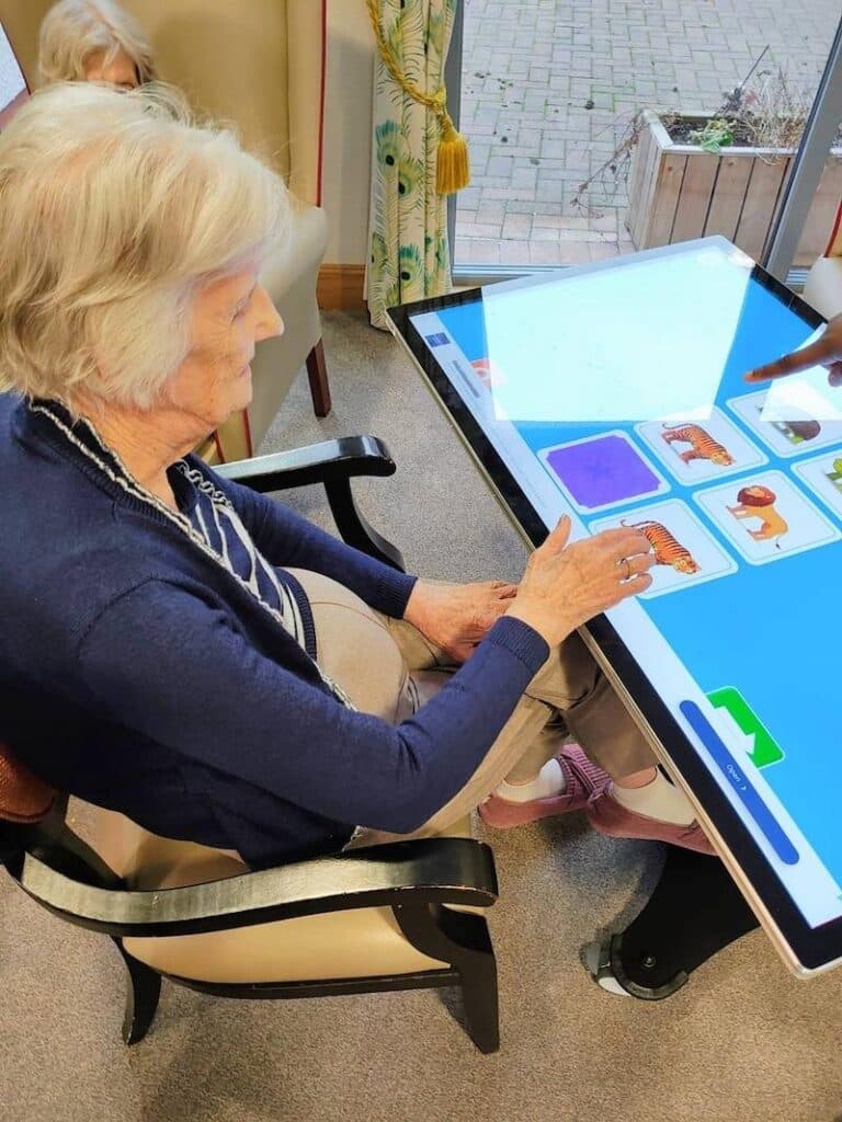 resident playing pairs on an interactive tablet in a care home